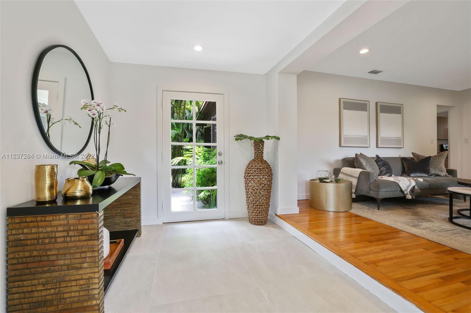 440 Blue Road Coral Gables, FL 33146 - Photo 3 of 20 a living room with furniture a window and a potted plant