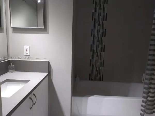 a bathroom with a sink a vanity and a bathtub