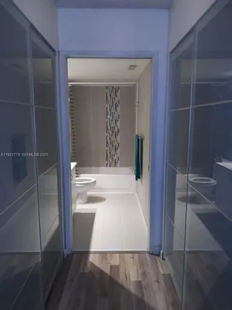 a view of walk in closet and living room