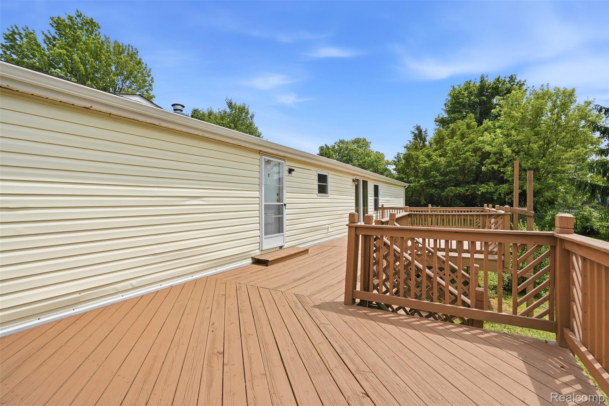 4420 Dublin Road Burton, MI 48529 - Photo 37 of 56 Expansive outdoor deck featuring wood decking and a tiered design