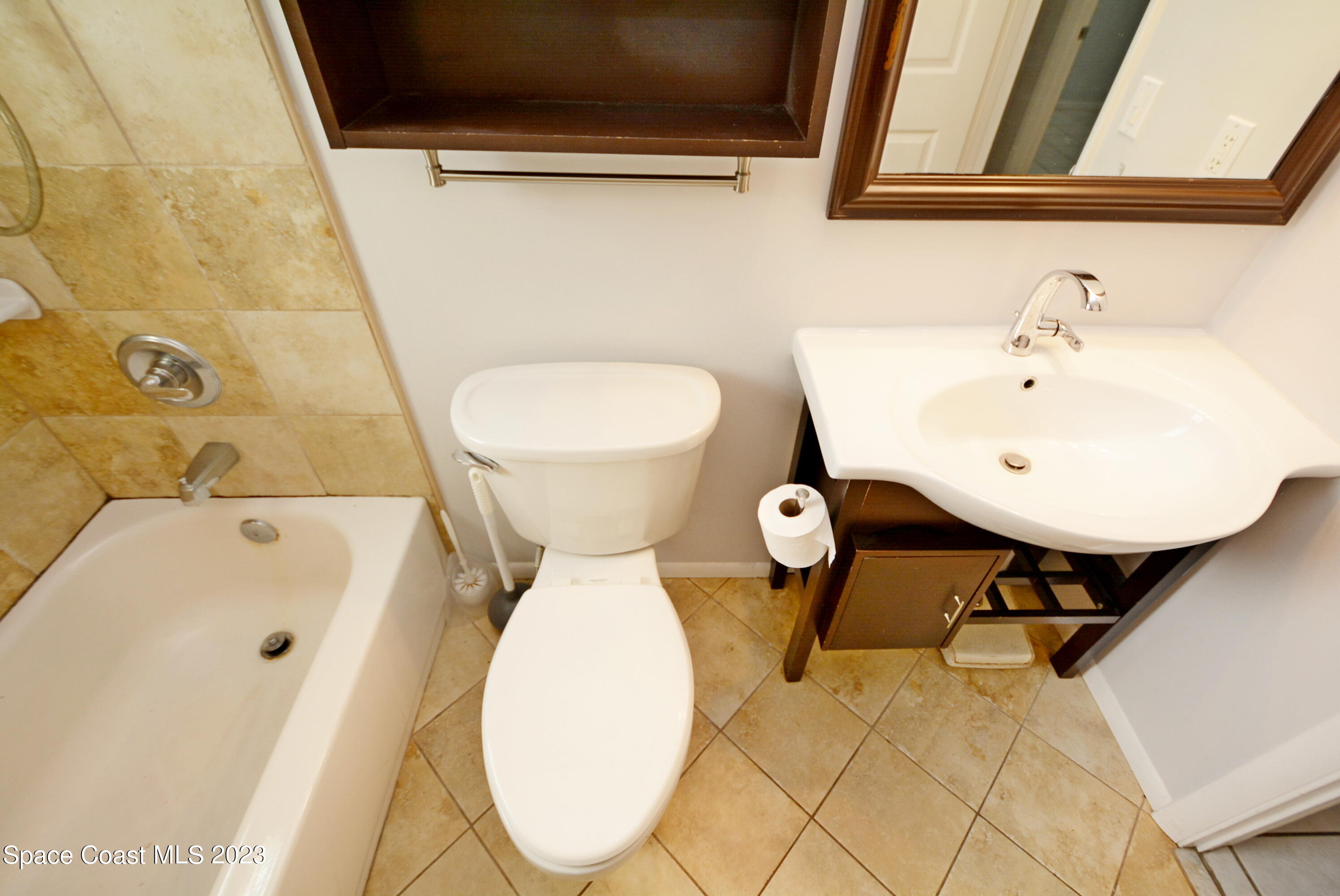 2579 Coventry Road Melbourne, FL 32935 - Photo 11 of 36 a bathroom with a sink and a mirror