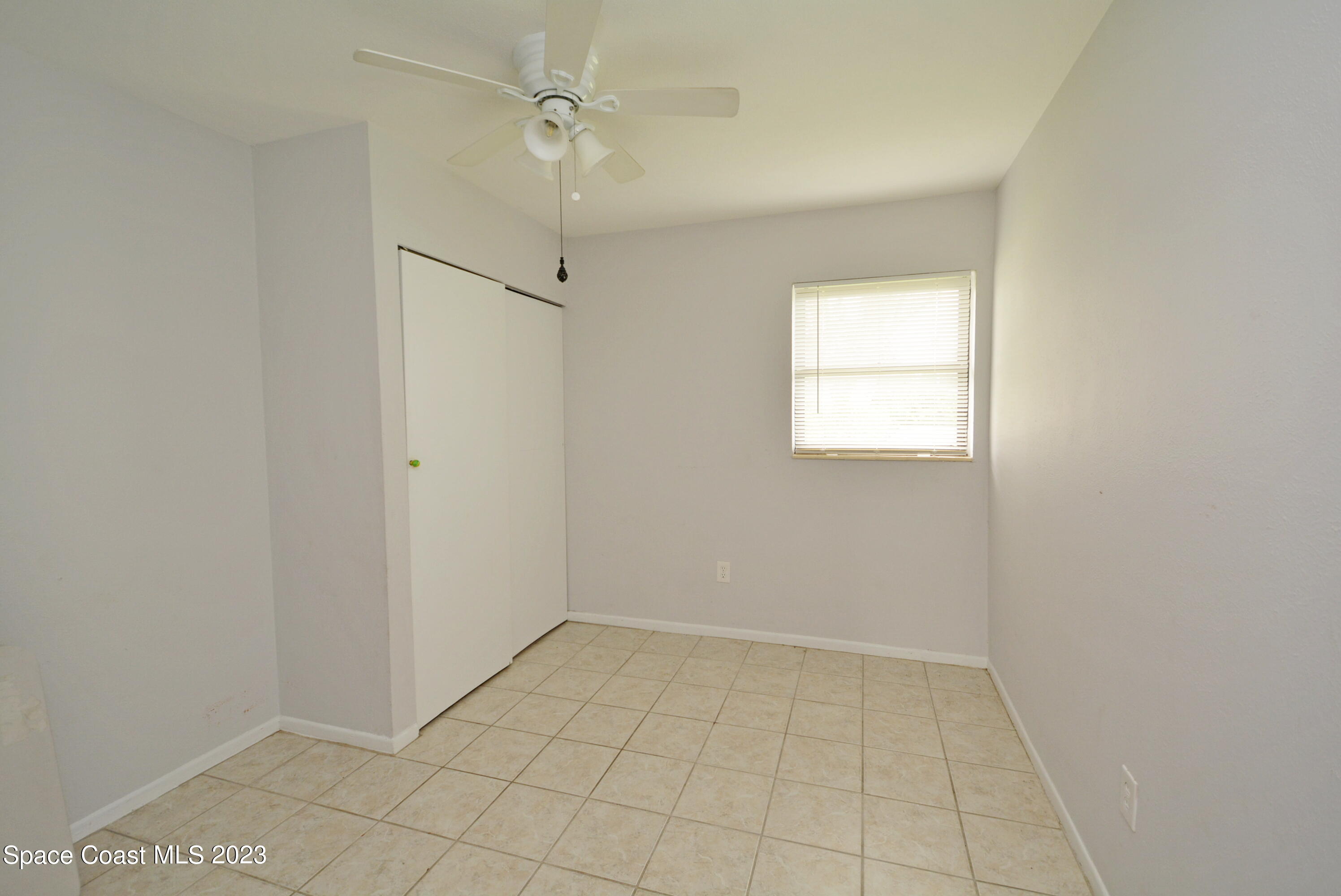 2579 Coventry Road Melbourne, FL 32935 - Photo 12 of 36 wooden floor in an empty room with a window