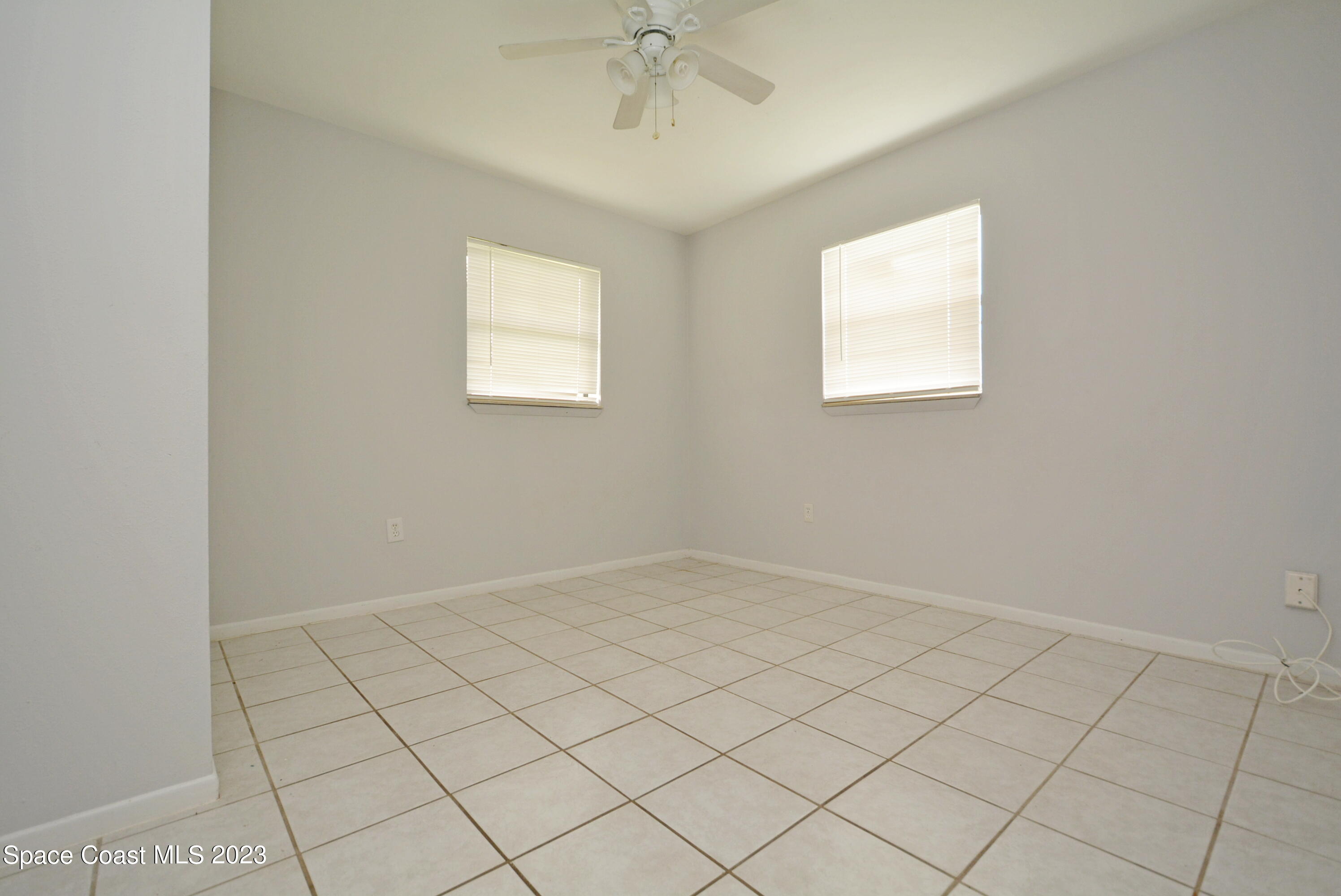 2579 Coventry Road Melbourne, FL 32935 - Photo 13 of 36 an empty room with a chandelier fan