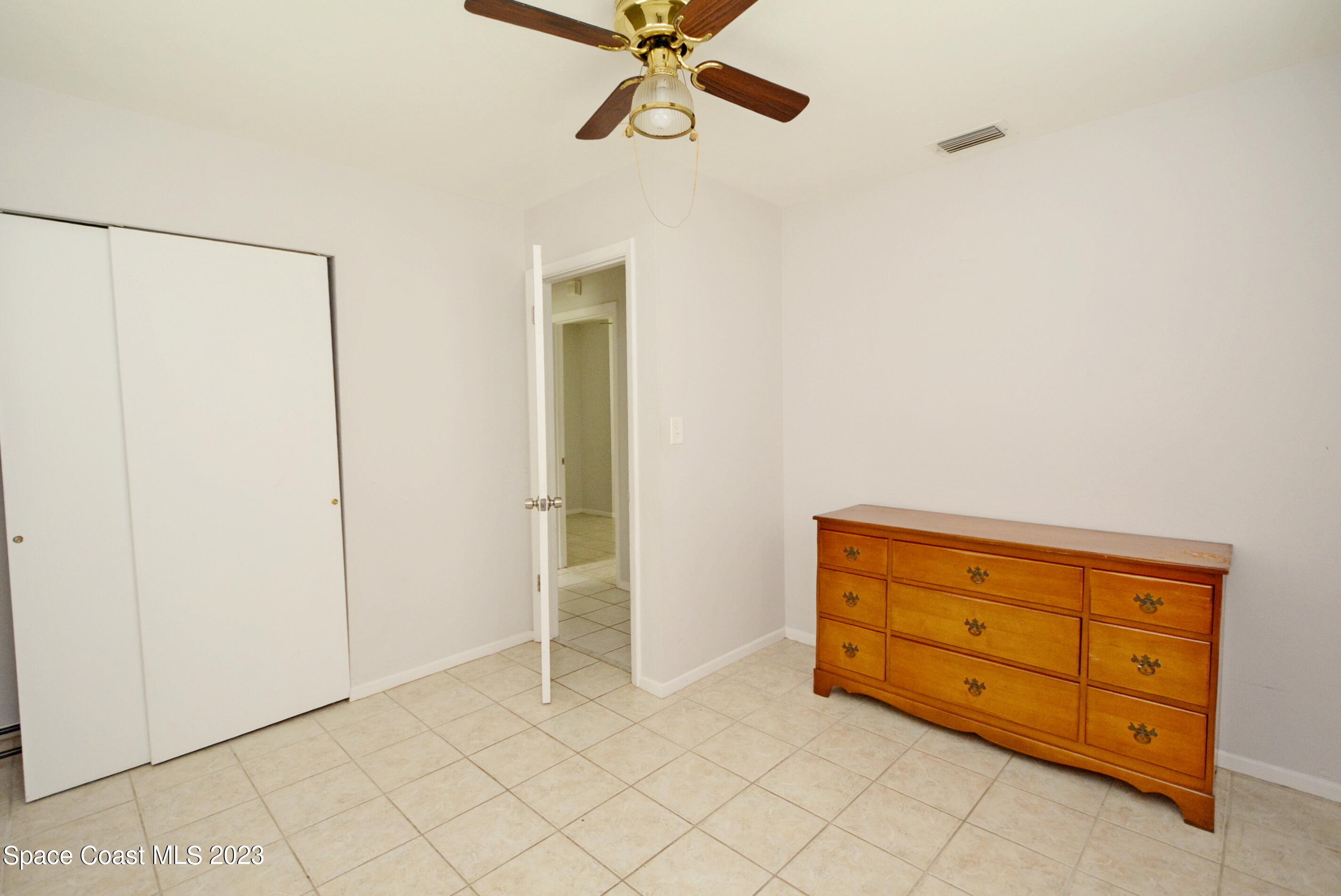 2579 Coventry Road Melbourne, FL 32935 - Photo 14 of 36 a view of room with cabinet and fan