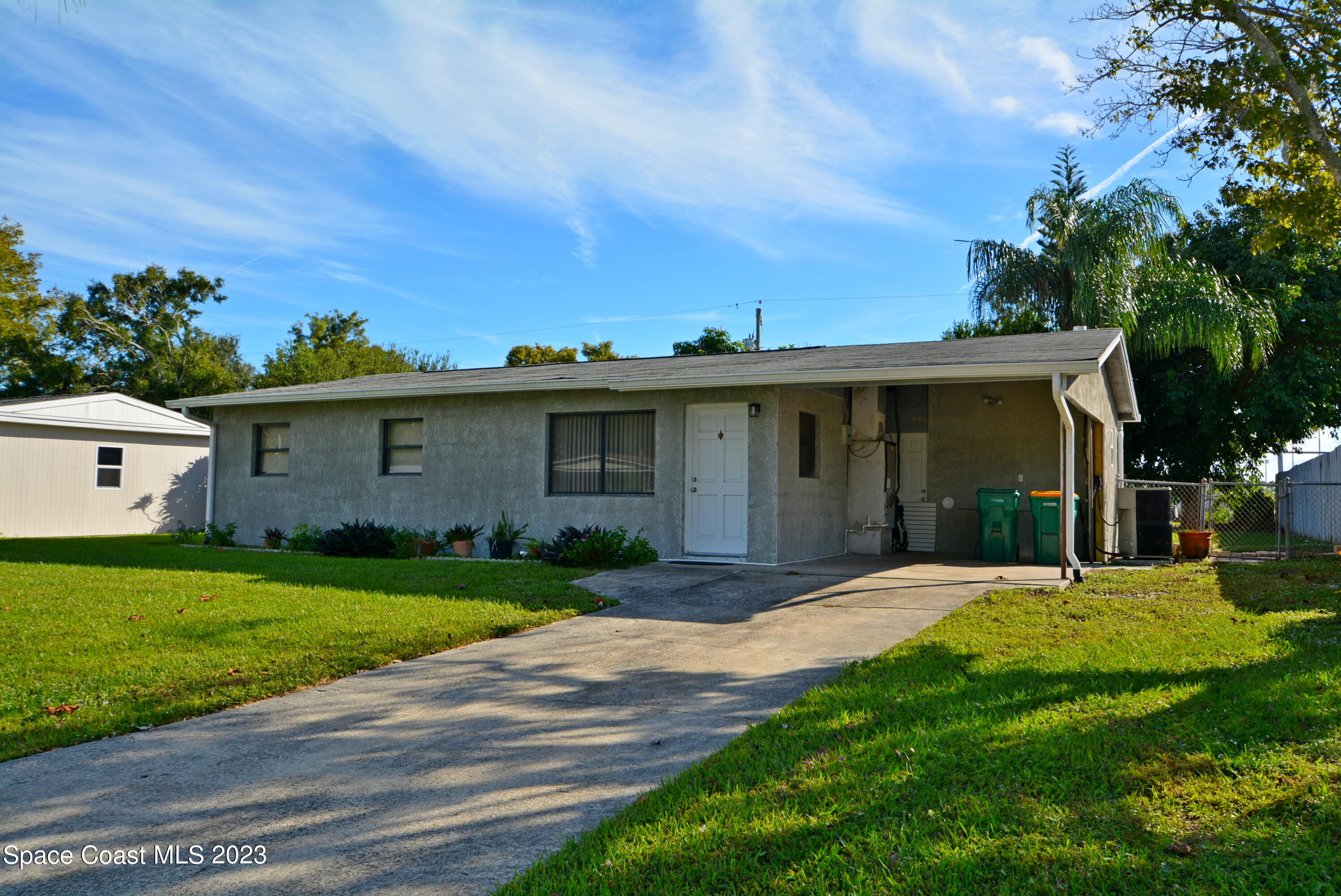 2579 Coventry Road Melbourne, FL 32935 - Photo 2 of 36 a front view of a house with a garden and yard