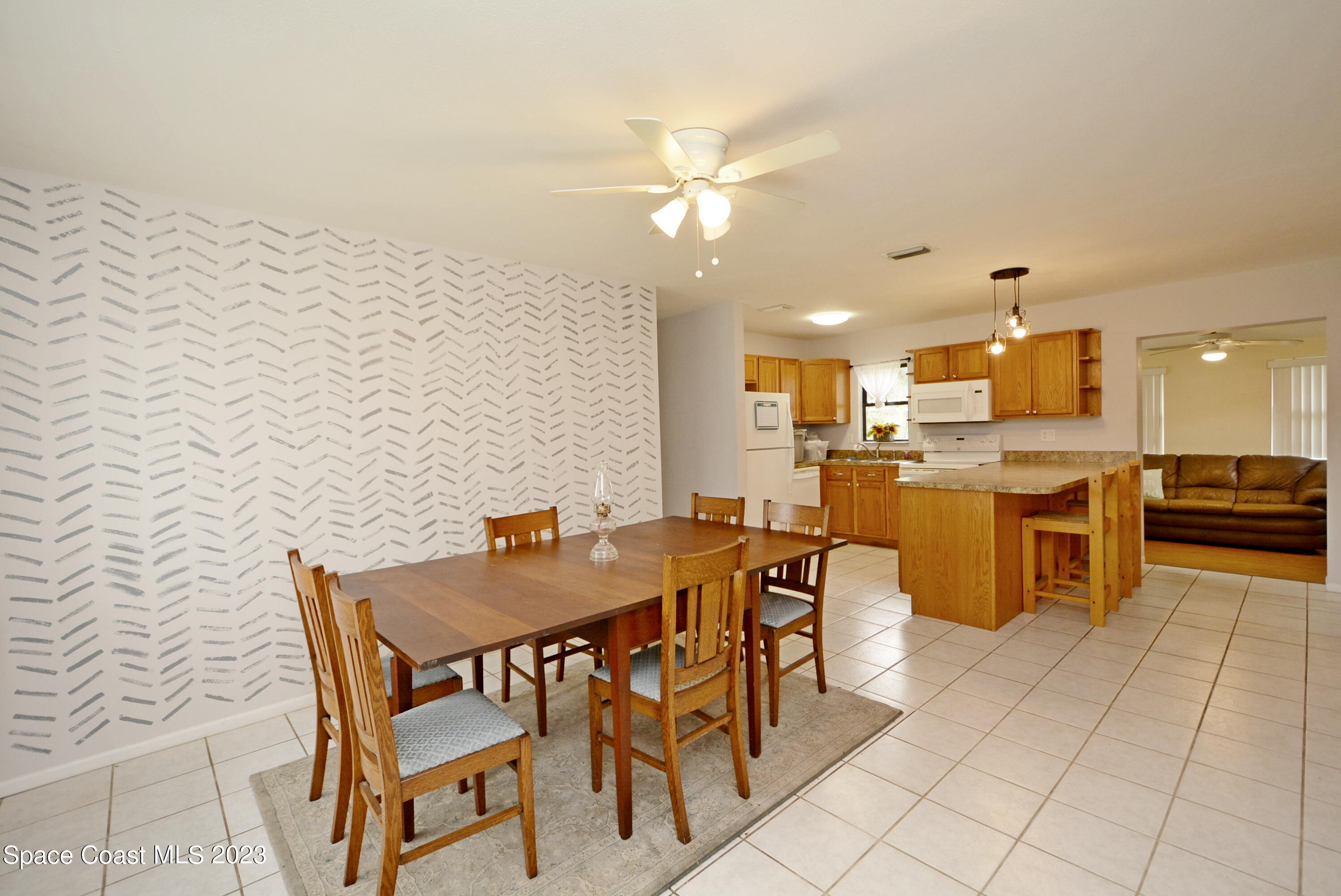 2579 Coventry Road Melbourne, FL 32935 - Photo 22 of 36 a view of a dining room kitchen and a window