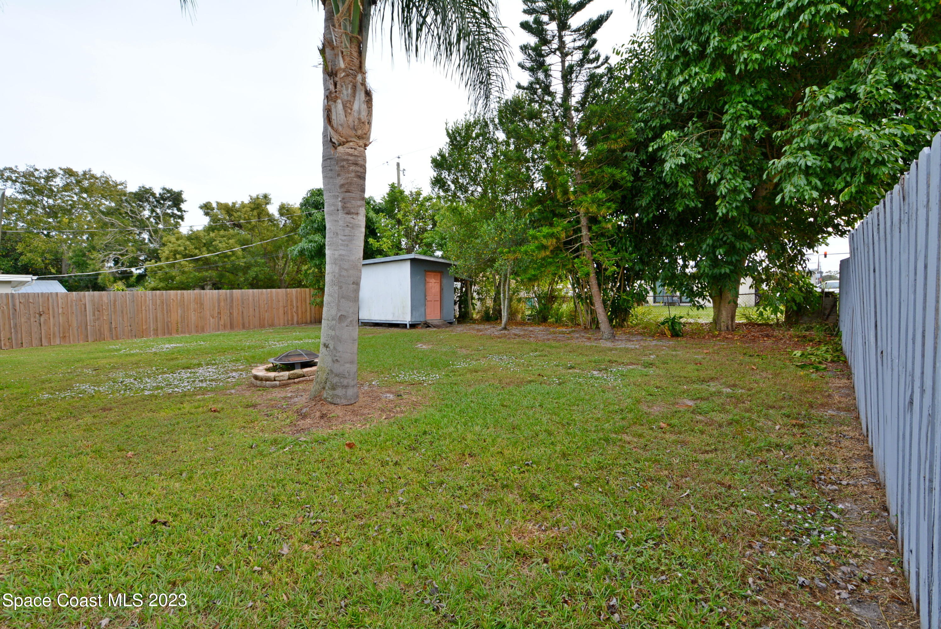 2579 Coventry Road Melbourne, FL 32935 - Photo 26 of 36 a backyard of a house with table and chairs