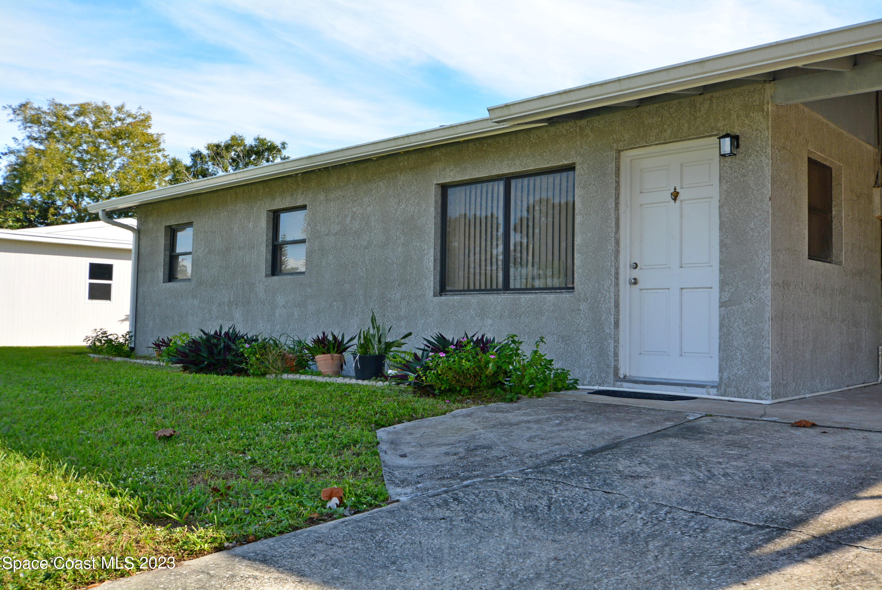 2579 Coventry Road Melbourne, FL 32935 - Photo 3 of 36 a front view of a house with garden
