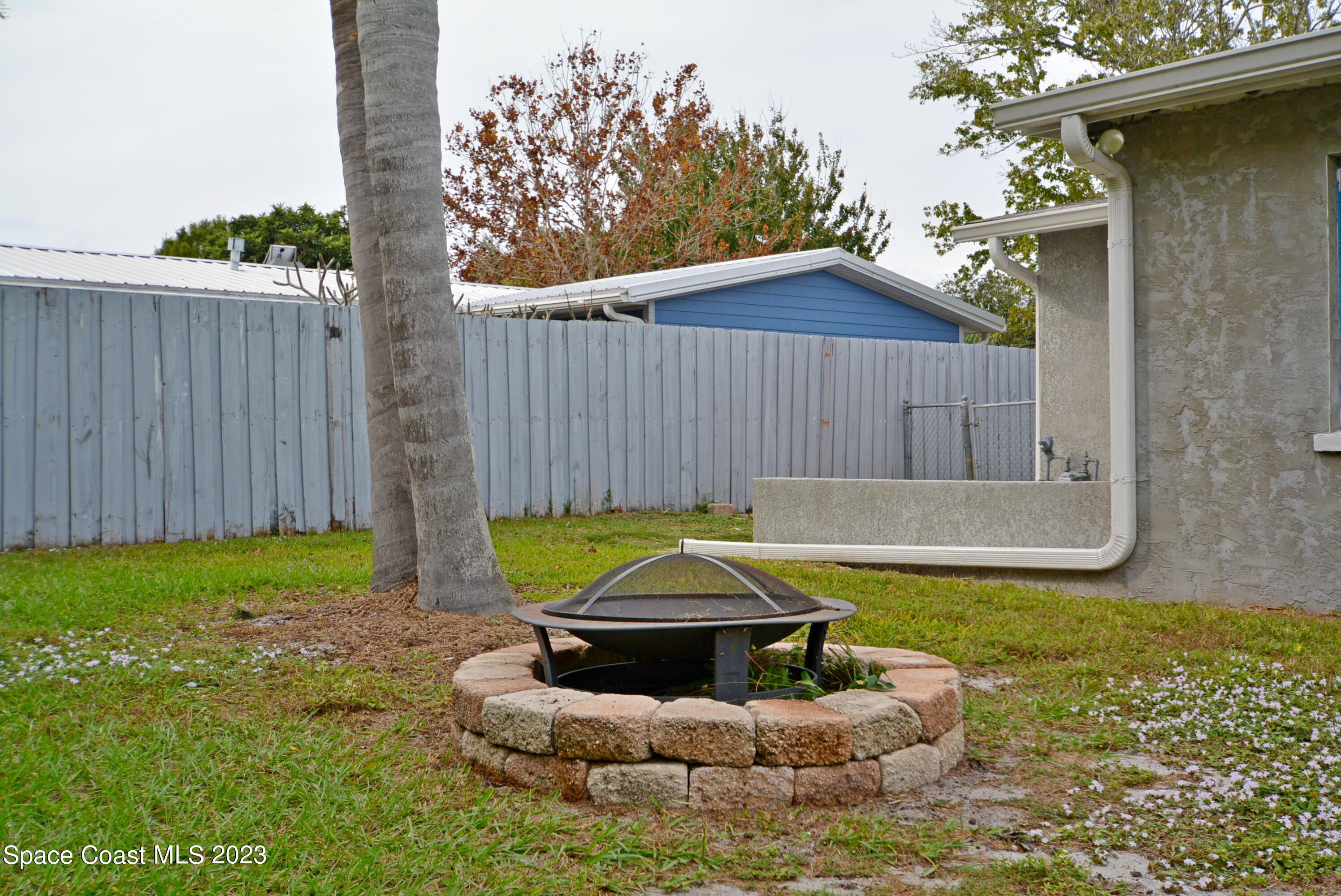 2579 Coventry Road Melbourne, FL 32935 - Photo 32 of 36 a swimming pool with some trees in the background