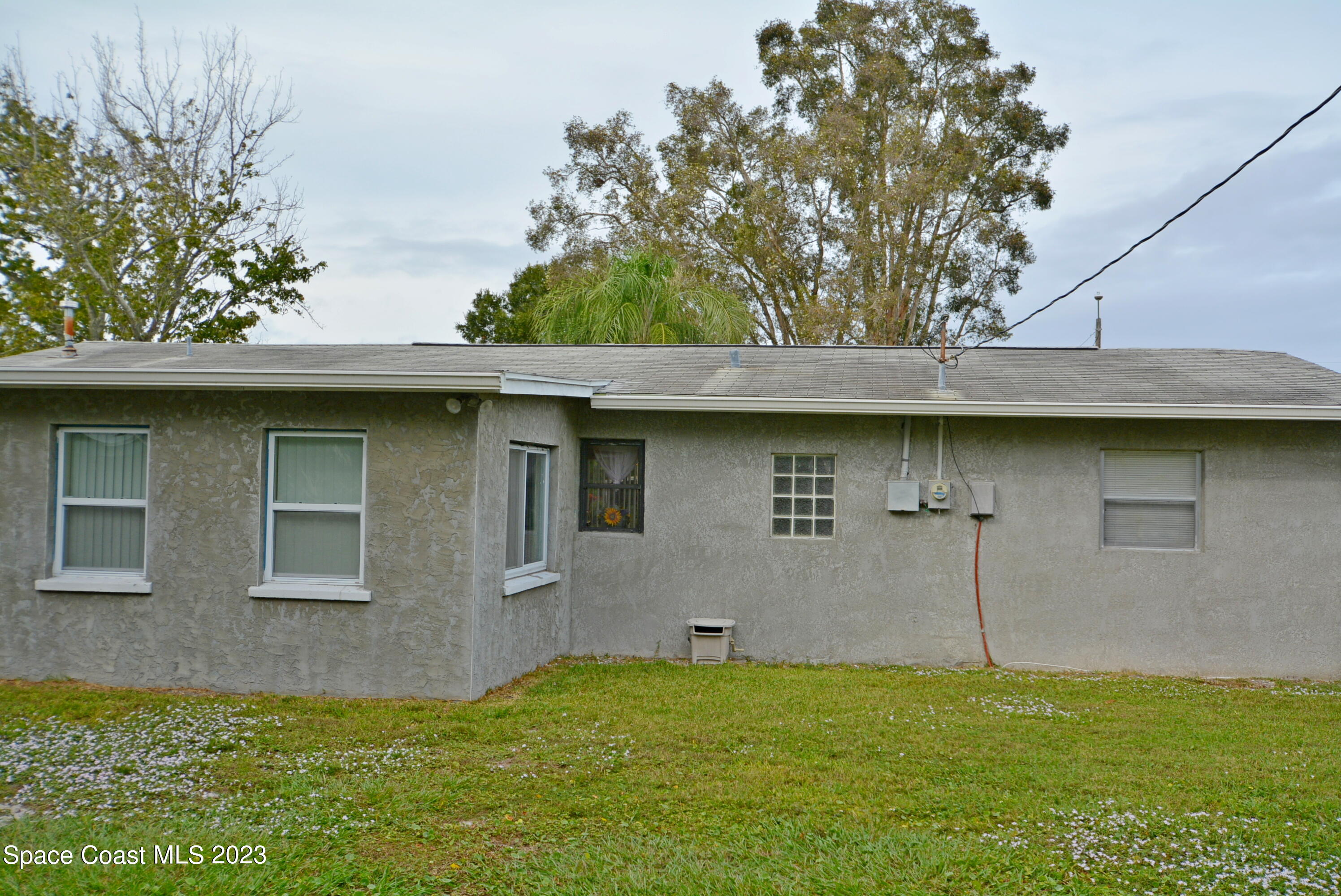 2579 Coventry Road Melbourne, FL 32935 - Photo 35 of 36 a house with a sink yard and a large tree