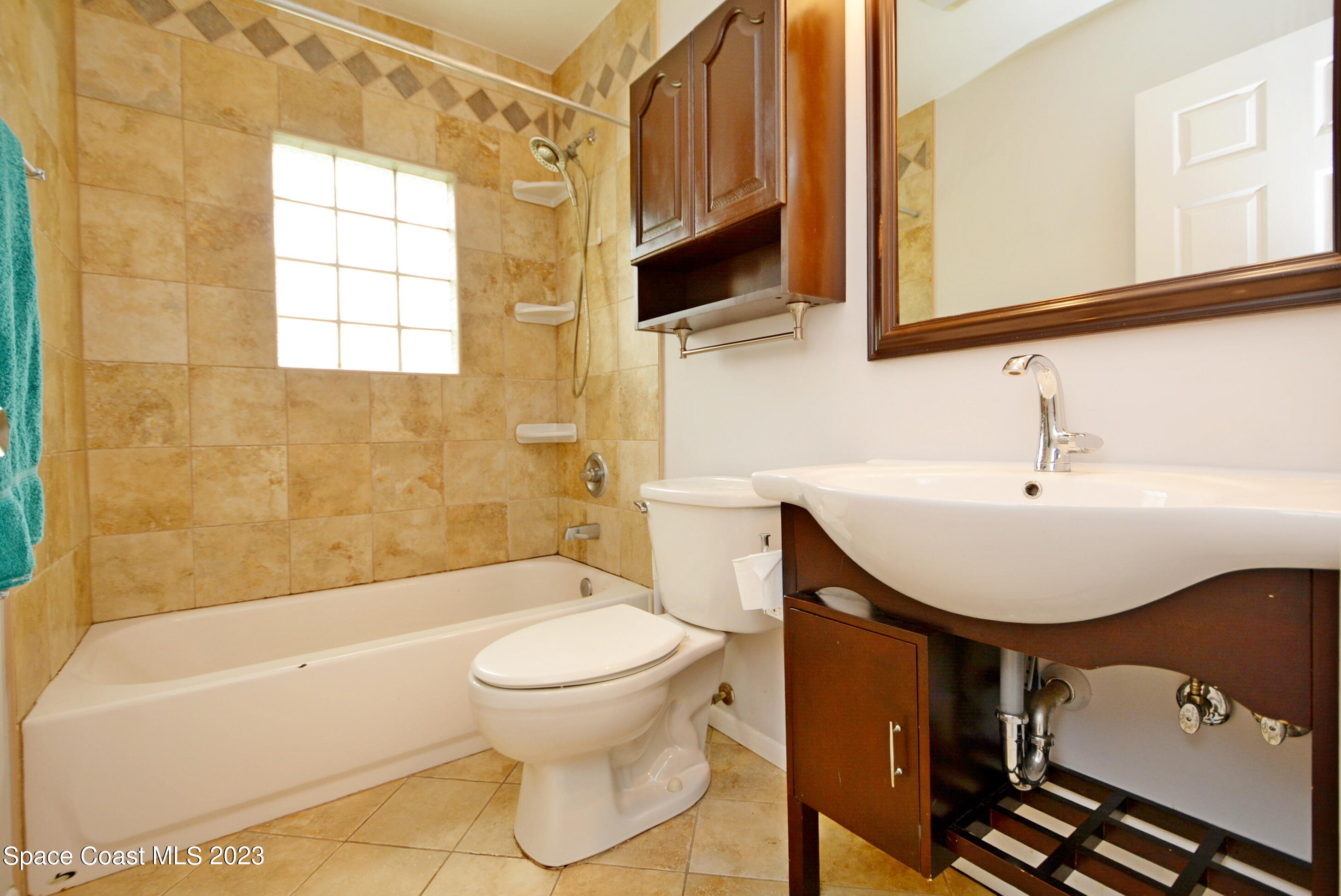 2579 Coventry Road Melbourne, FL 32935 - Photo 9 of 36 a bathroom with a sink a toilet and shower