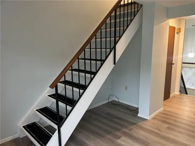 a view of entryway with wooden floor and stairs