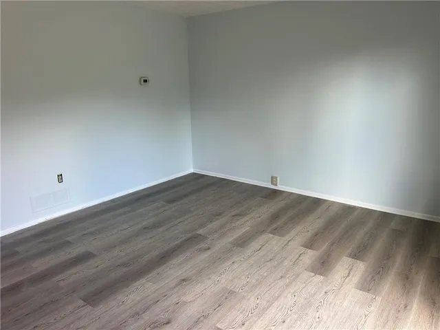 a view of room with wooden floor