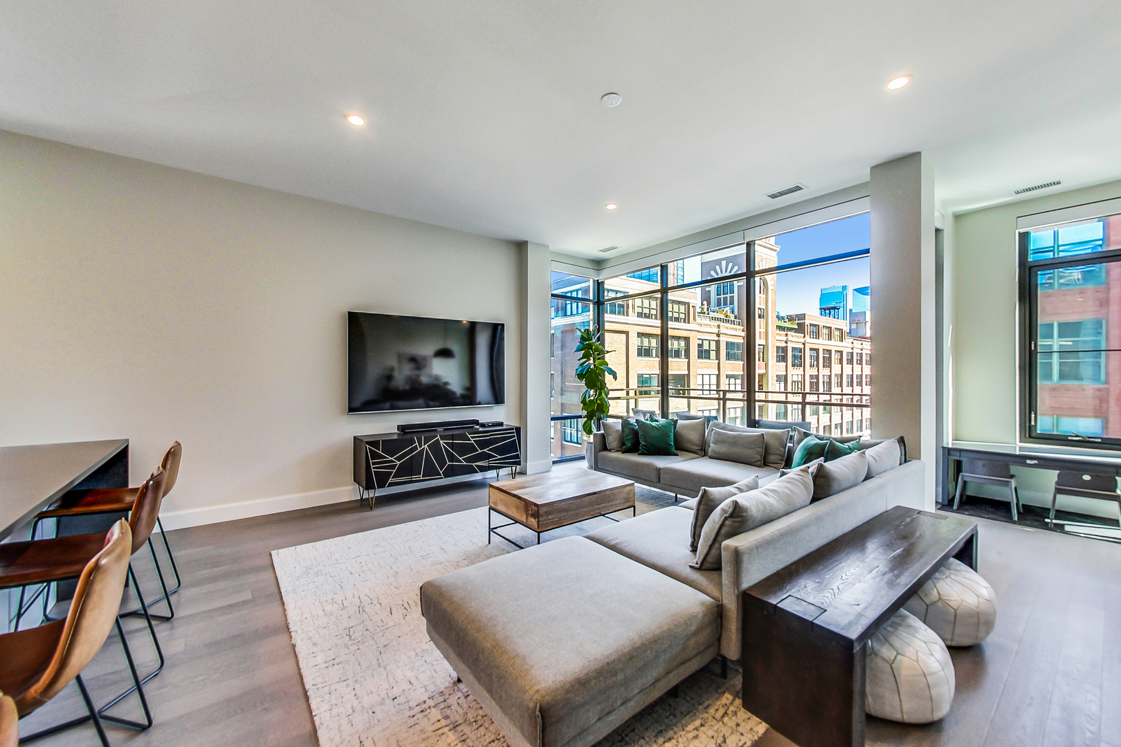 40 North Carpenter Street, Unit 5N Chicago, IL 60607 - Photo 2 of 29 a living room with furniture and a flat screen tv