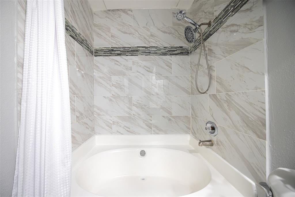 4113 Esters Road, Unit 609 Irving, TX 75038 - Photo 13 of 24 a bathroom with a white bath tub and a shower