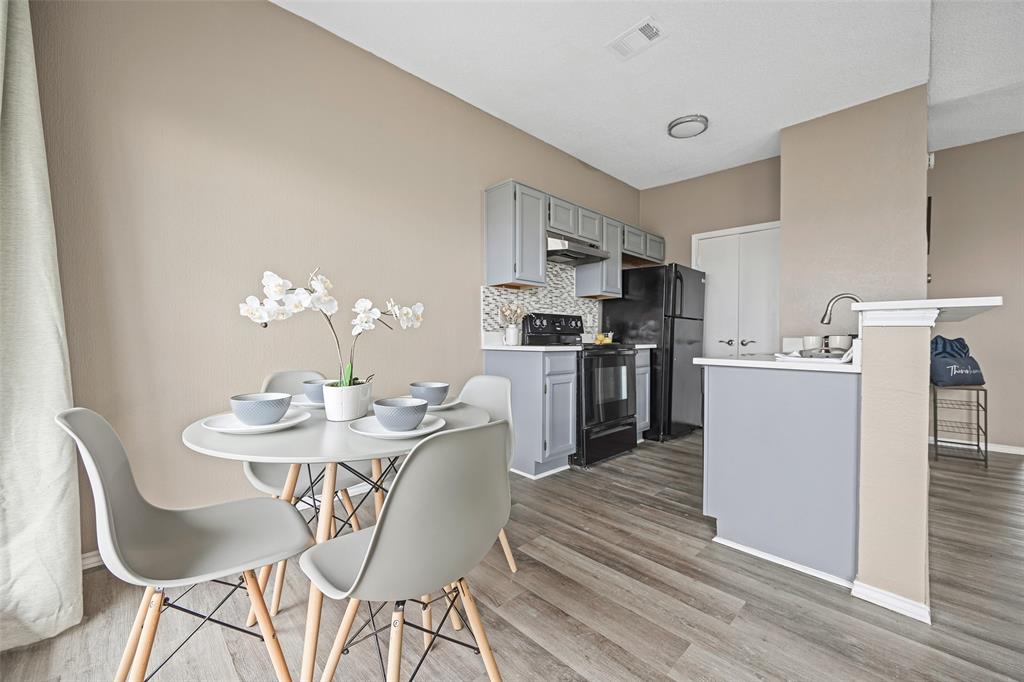 4113 Esters Road, Unit 609 Irving, TX 75038 - Photo 3 of 24 a view of a dining room with furniture and wooden floor
