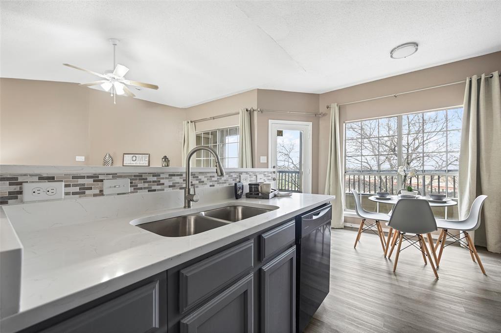 4113 Esters Road, Unit 609 Irving, TX 75038 - Photo 5 of 24 a kitchen with a sink and wooden floor