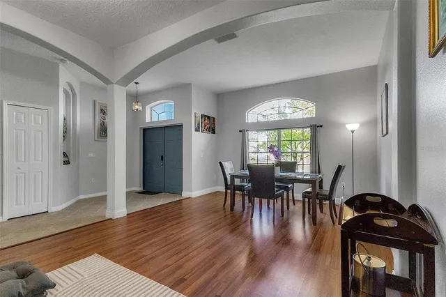 a view of a dining room with furniture and wooden floor