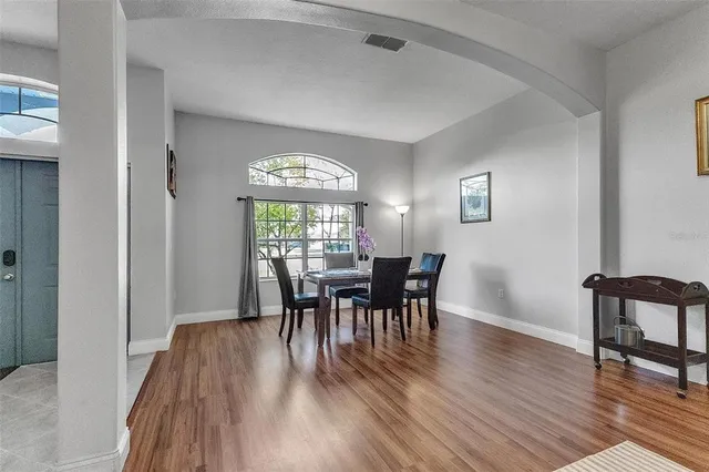a view of a dining room with furniture and wooden floor