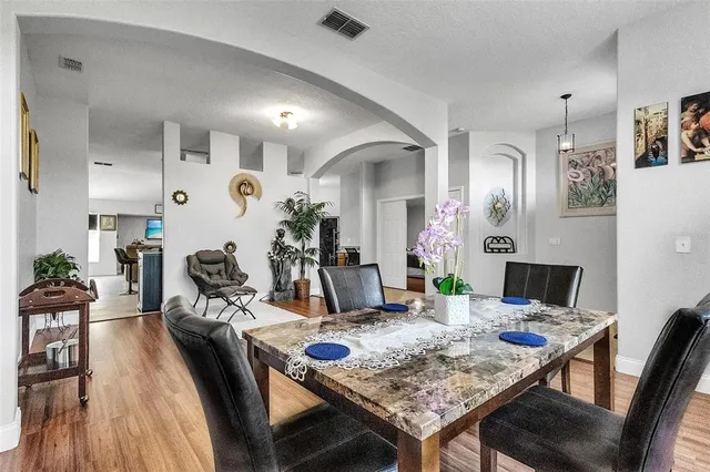 a view of a dining room with furniture and wooden floor