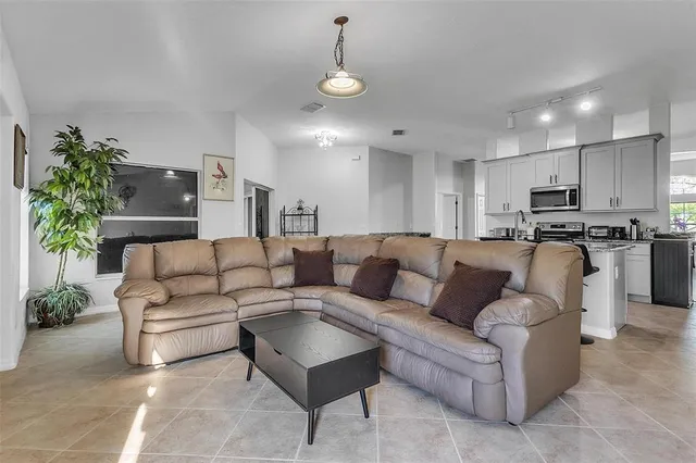 a living room with furniture and kitchen view