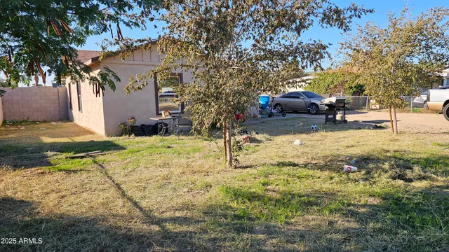 a view of a yard with cars