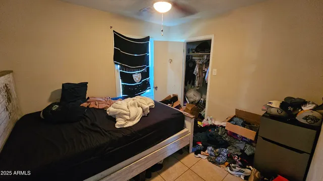 a bedroom with a bed and a window