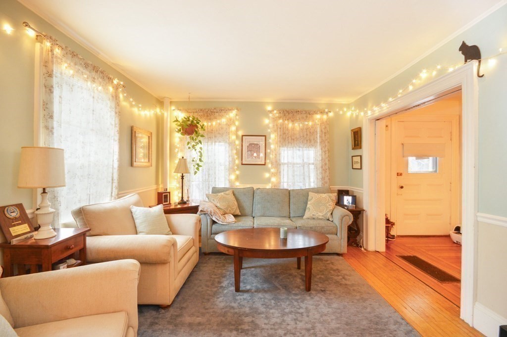 3 Hunnewell Street Melrose, MA 02176 - Photo 11 of 33 a living room with furniture and a large window