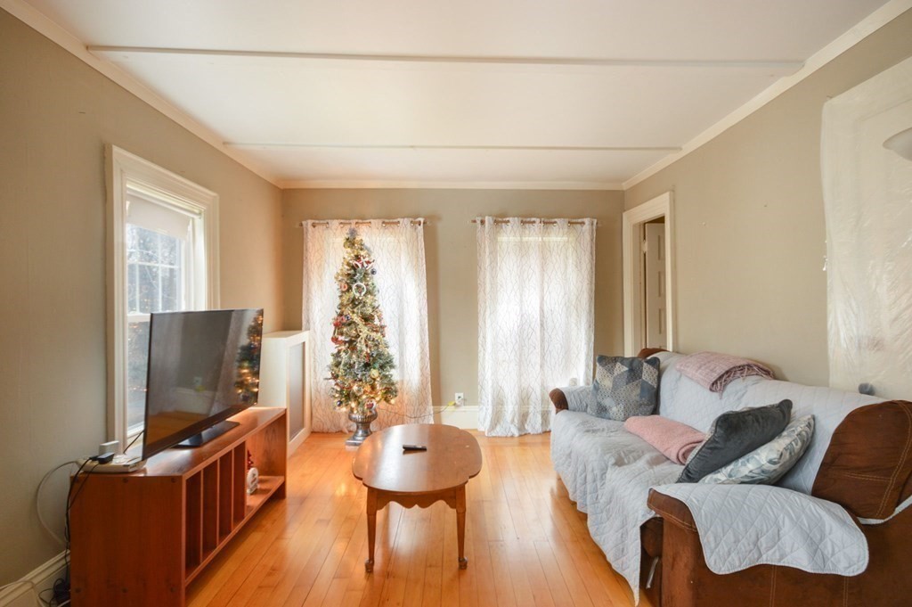 3 Hunnewell Street Melrose, MA 02176 - Photo 20 of 33 a living room with furniture and a flat screen tv