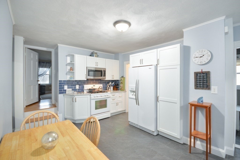 3 Hunnewell Street Melrose, MA 02176 - Photo 7 of 33 a kitchen with stainless steel appliances a refrigerator and a stove top oven