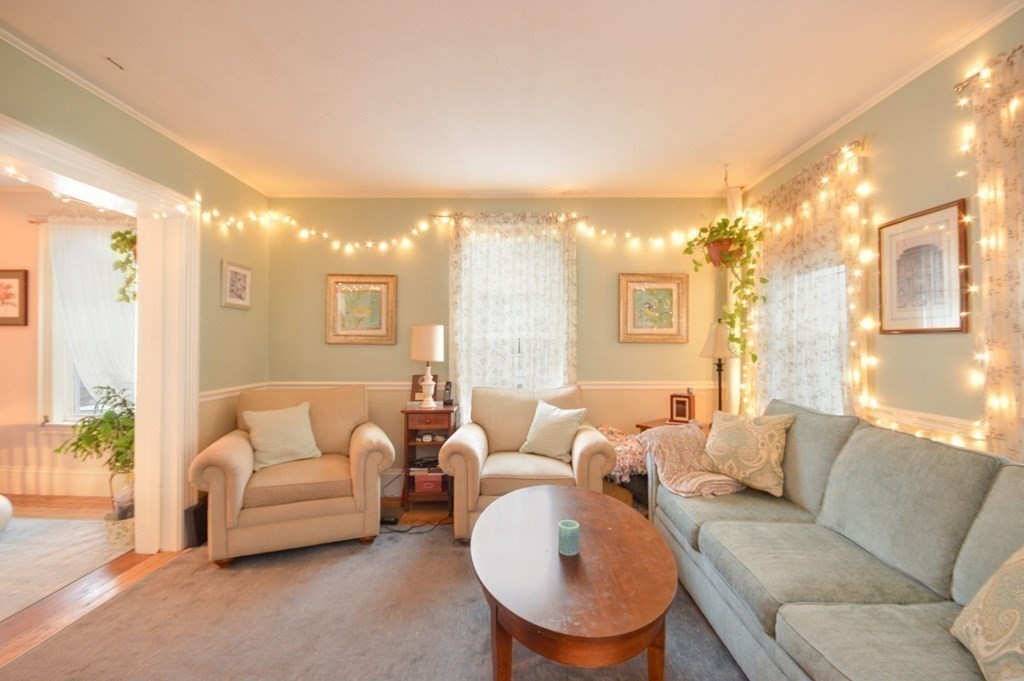 3 Hunnewell Street Melrose, MA 02176 - Photo 10 of 33 a living room with furniture and a large window