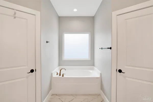 a bathroom with a bathtub and shower