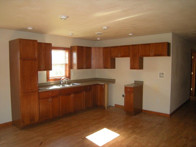 1755 Winding Road Amboy, IL 61310 - Photo 3 of 10 a kitchen with granite countertop a refrigerator a sink and dishwasher