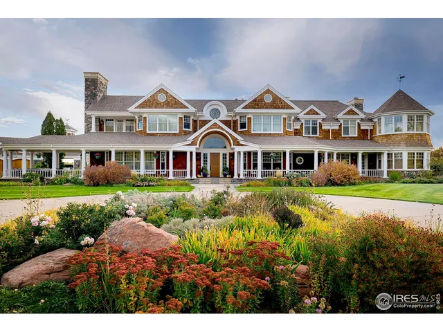 a front view of residential houses with yard and green space