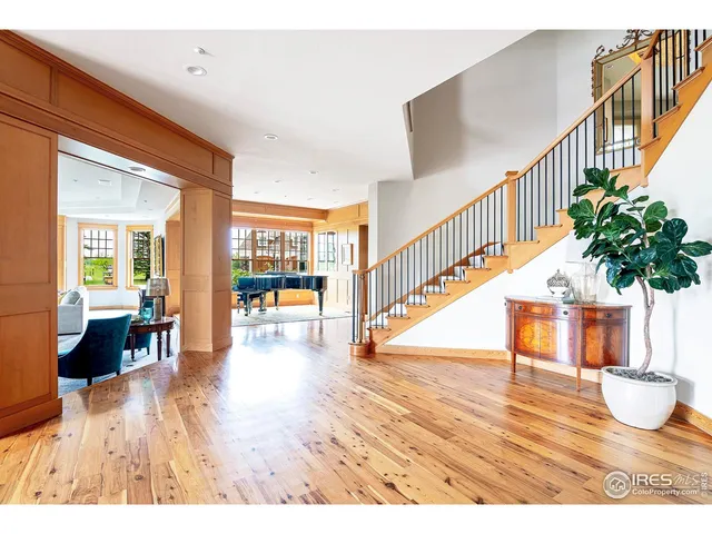 a living room with furniture a large window and a fireplace