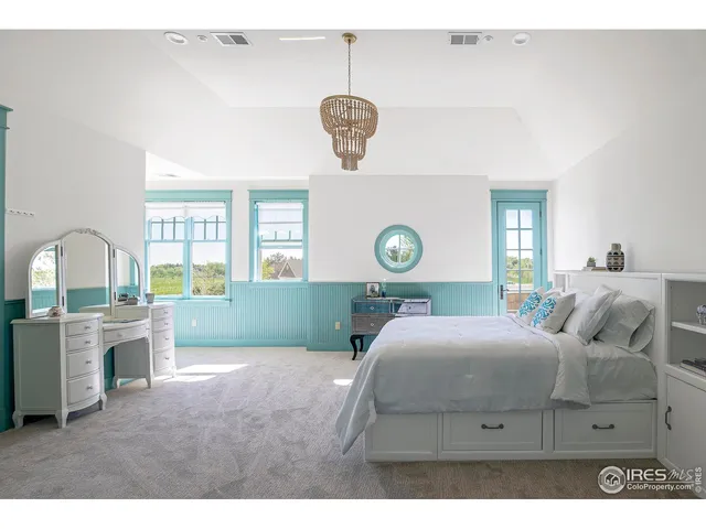 a spacious bedroom with a large bed and a large window