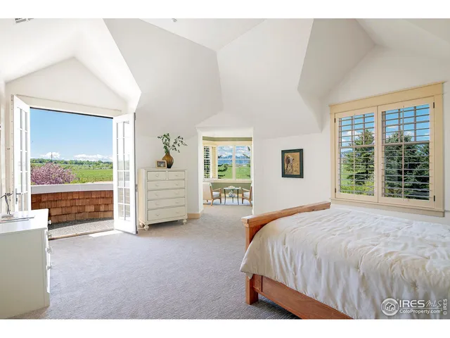 a living room with furniture floor to ceiling window and wooden floor