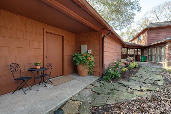 a view of a house with backyard porch and sitting area