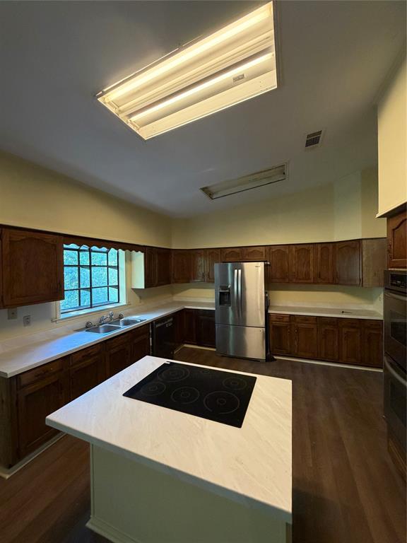 257 West Acres Road Gun Barrel City, TX 75156 - Photo 5 of 22 a kitchen with stainless steel appliances a stove a sink and a microwave