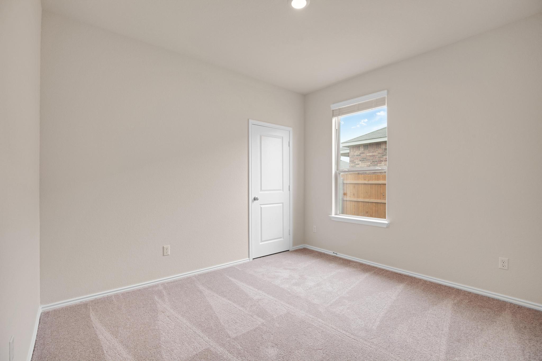 200 Janice Road Taylor, TX 76574 - Photo 18 of 25 A well-lit bedroom offering a blank canvas for personalization.