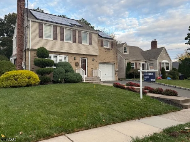 a view of a house with backyard and a tree