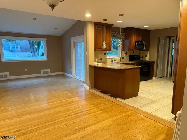 a view of kitchen with wooden floor