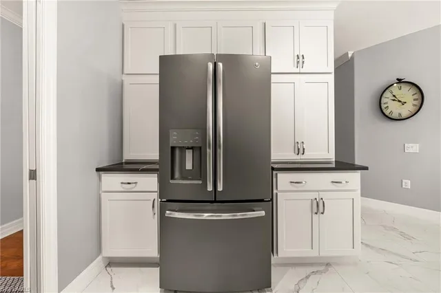 a kitchen with stainless steel appliances granite countertop a refrigerator and a stove