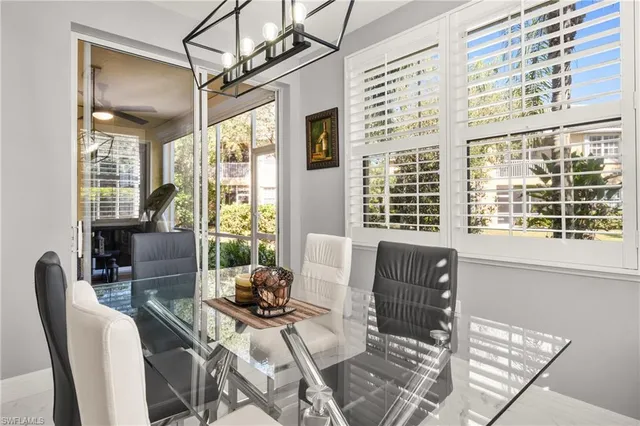 a living room with furniture and floor to ceiling windows