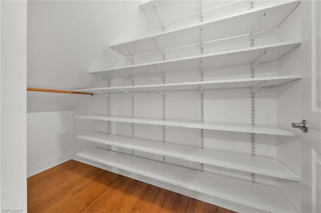 a view of walk in closet with empty racks