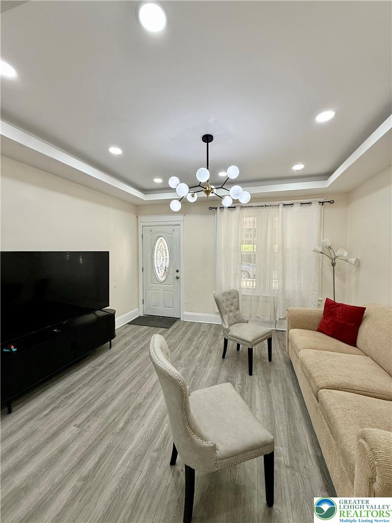 1025 Spring Street Bethlehem, PA 18018 - Photo 4 of 20 Laminated wood flooring extends through this naturally illuminated, spacious living area, crowned with recessed lighting and a unique chandelier.