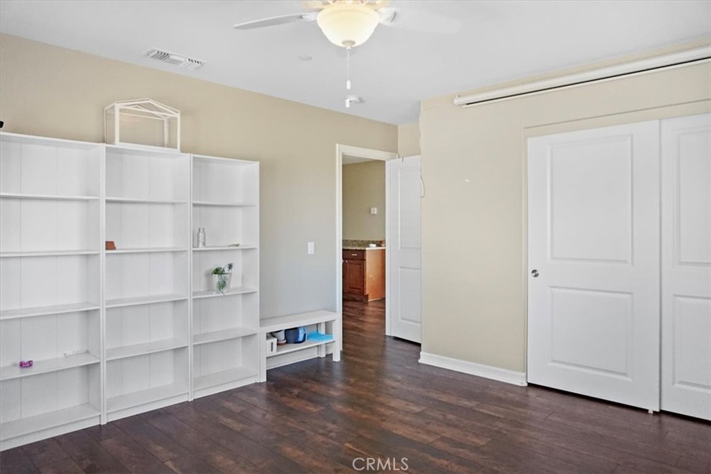14012 Quailridge Drive Riverside, CA 92503 - Photo 22 of 44 a view of an empty room with wooden floor and a window