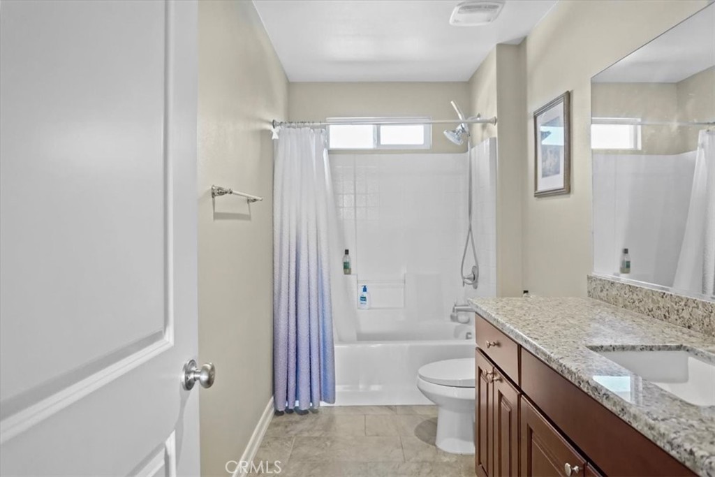 14012 Quailridge Drive Riverside, CA 92503 - Photo 23 of 44 a bathroom with a granite countertop sink toilet and shower