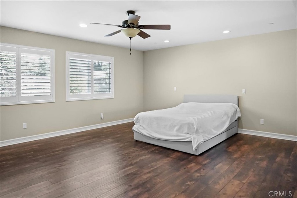 14012 Quailridge Drive Riverside, CA 92503 - Photo 24 of 44 a bedroom with a bed and a chandelier