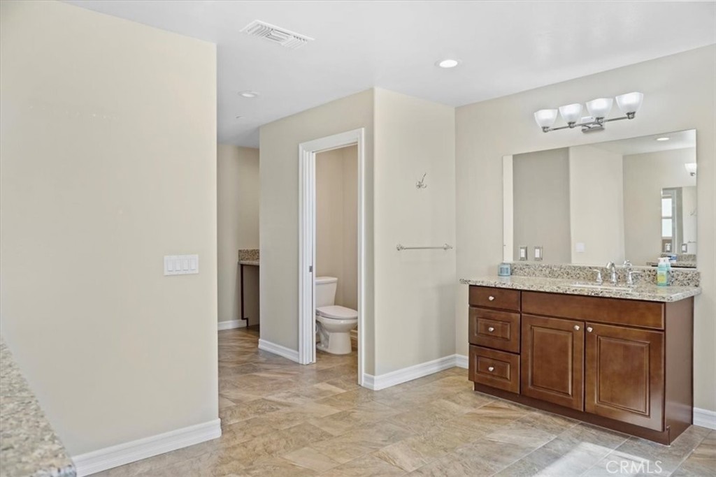 14012 Quailridge Drive Riverside, CA 92503 - Photo 31 of 44 a spacious bathroom with a granite countertop sink a mirror and a shower